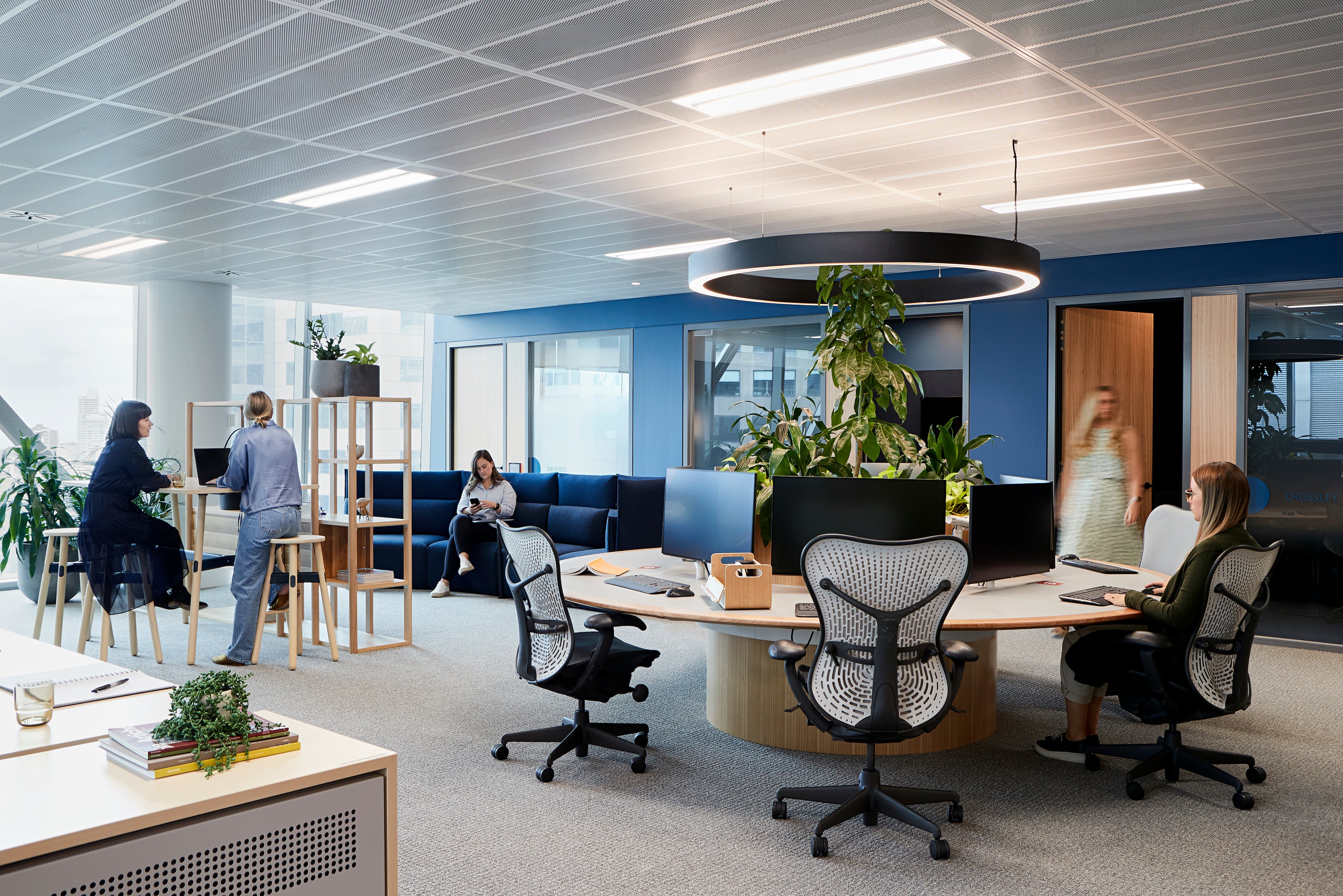 Illustration of a modern office environment with ergonomic workstation zones
